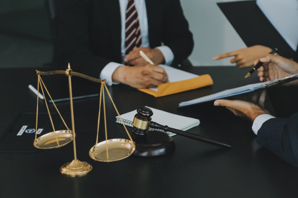 Two professional lawyers in suits discussing a case beside a law scale, symbolizing trust and digital growth for law firms